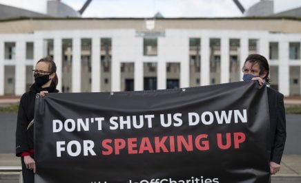 Don't Shut us Down for Speaking Up banner held in front of Parliament House
