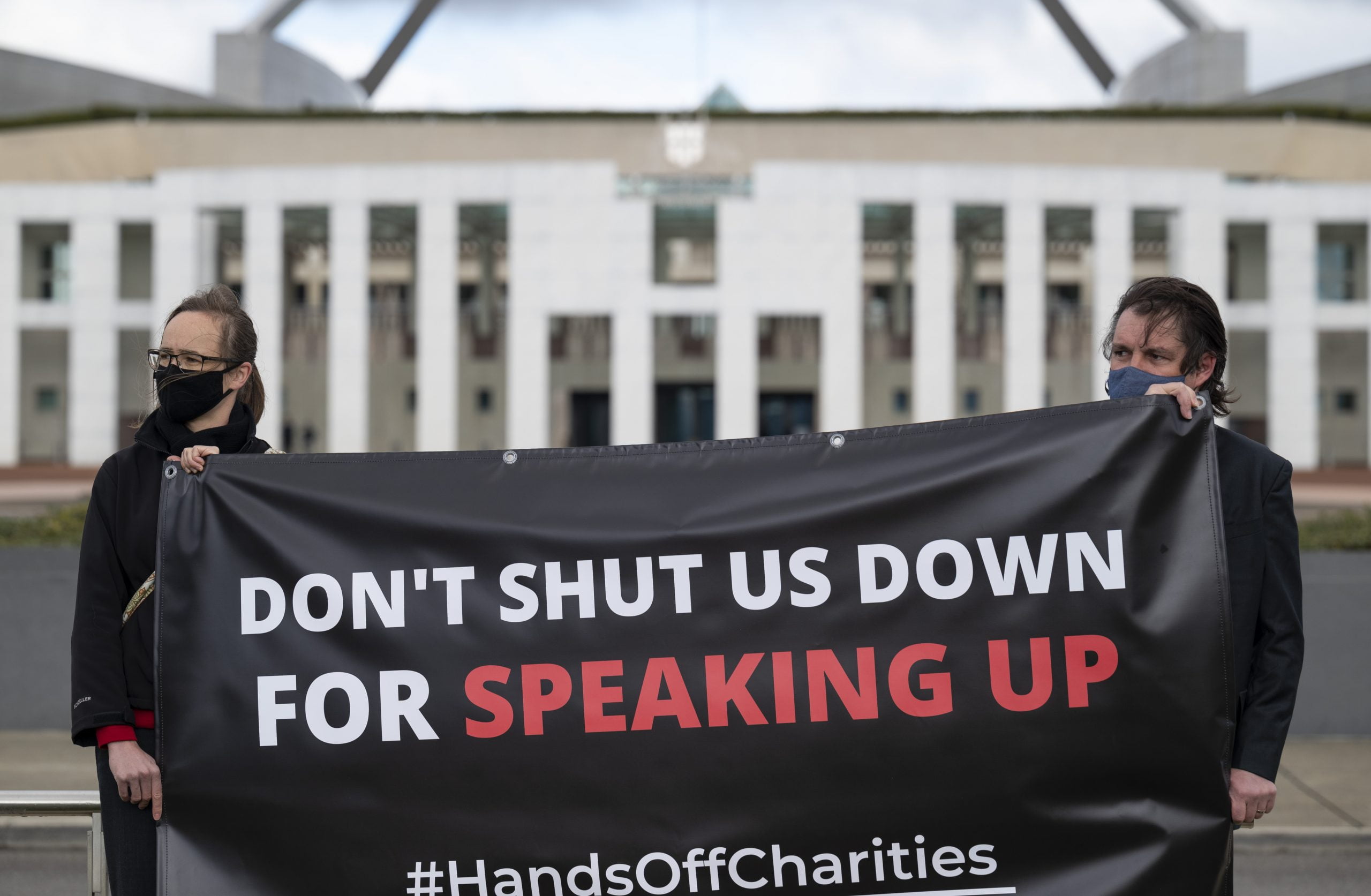 Don't Shut us Down for Speaking Up banner held in front of Parliament House