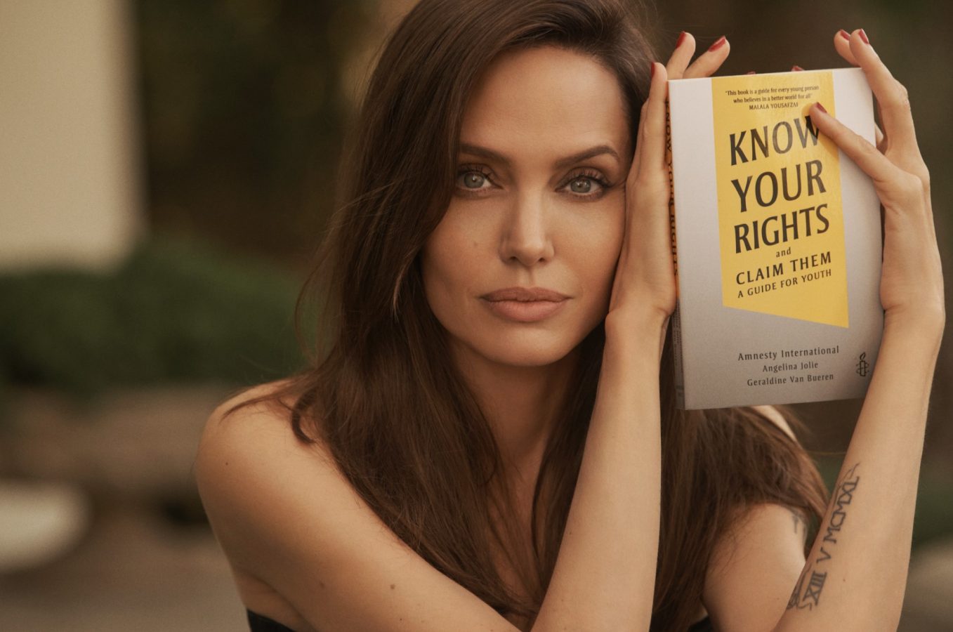 Angelina Jolie with the book 'Know Your Rights and Claim Them'