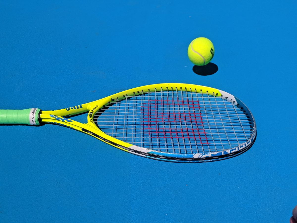 An image of a tennis racket against a blue background.