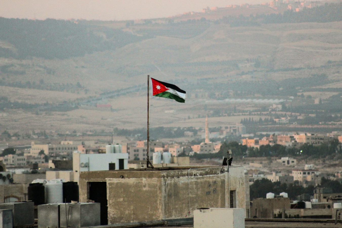 Flag of Jordan flying above a building