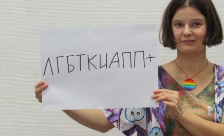 Yulia holds up a sign that says 