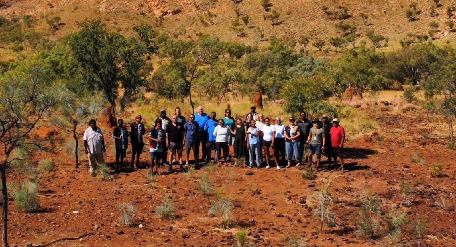 A wide shot of people standing on country, from the Olabud Doogethu Project in the Kimberley.